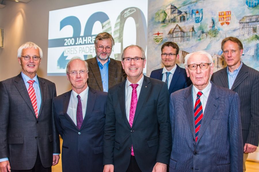 Reinold Stücke (Landrat von 1993 bis 1999), Dr. Rudolf Wansleben (Oberkreisdirktor von 1993 bis 1999 und Landrat von 1999 bis 2004), Landrat Manfred Müller, Werner Henke (Oberkreisdirektor von 1965 bis 1992), dahinter: Wilhelm Grabe (Archivar Kreis Paderborn), Dr. Stephen Schröder (Archivar Rhein-Kreis-Neuss) und Dr. Hansjörg Riechert (Archivar Kreis Lippe). (Foto: Amt für Presse- und Öffentlichkeitsarbeit, Kreis Paderborn) bei der „Geburtstagsfeier“ im Kreishaus Paderborn